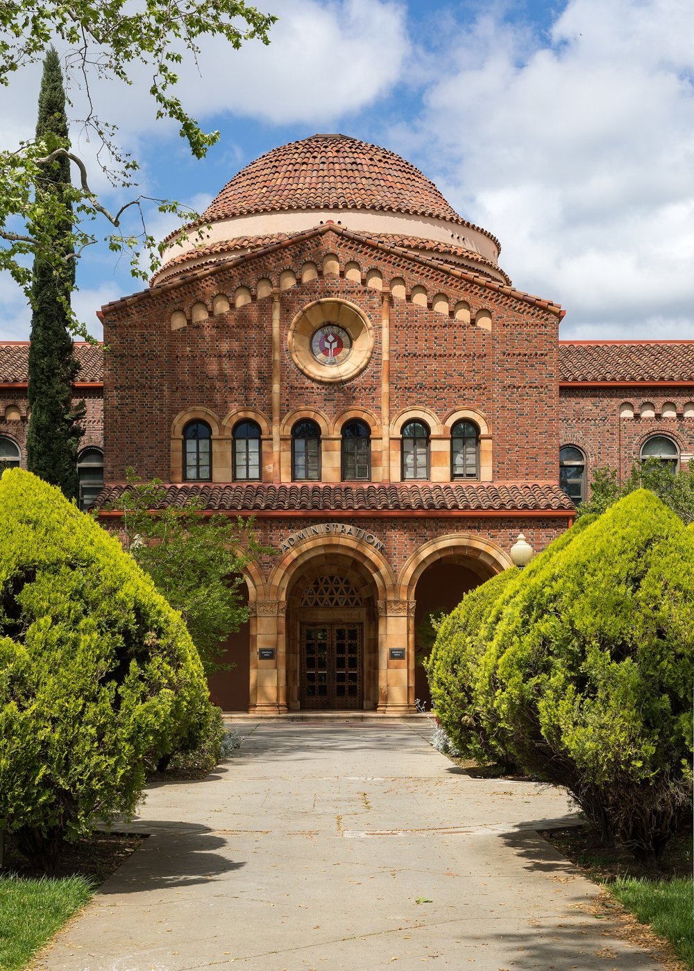 Kendall Hall at Chico State, a red brick building with a domed roof and arched entry